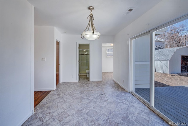 unfurnished dining area with visible vents and baseboards