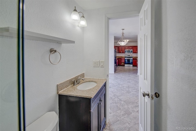 bathroom with toilet and vanity