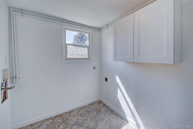 washroom with baseboards, cabinet space, and hookup for an electric dryer