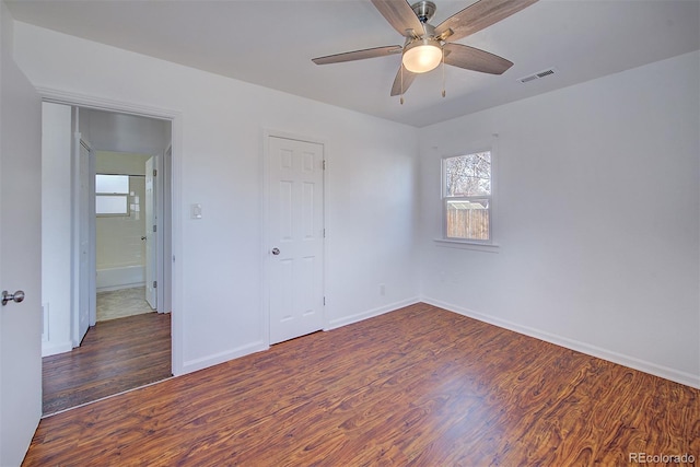 unfurnished bedroom with visible vents, baseboards, wood finished floors, and a ceiling fan