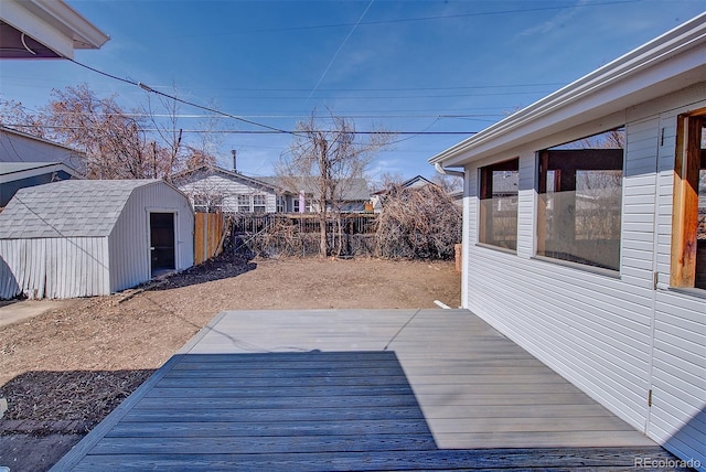 view of yard with a wooden deck, a storage shed, an outdoor structure, and fence