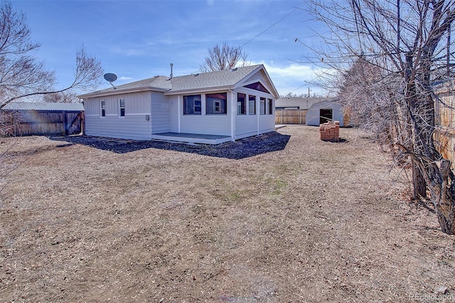 exterior space featuring roof with shingles and fence