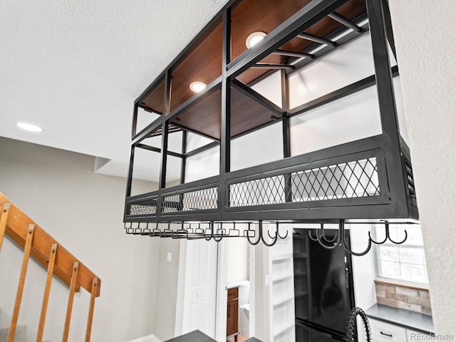 stairway featuring a textured ceiling