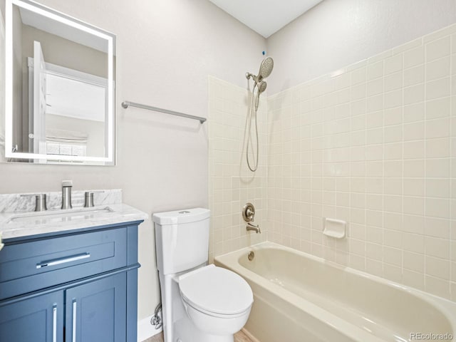 bathroom featuring toilet, vanity, and tub / shower combination