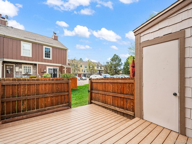 wooden terrace featuring a residential view and fence