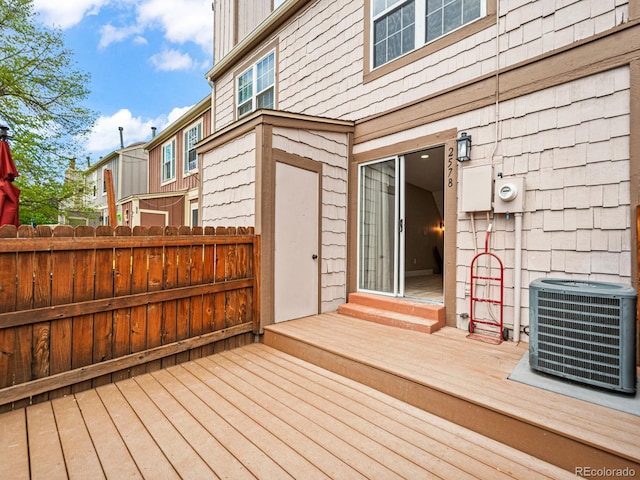 deck featuring cooling unit, fence, and entry steps