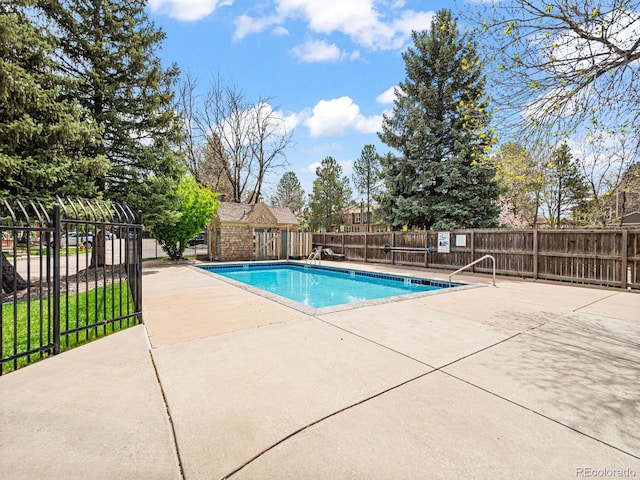 community pool featuring fence and a patio