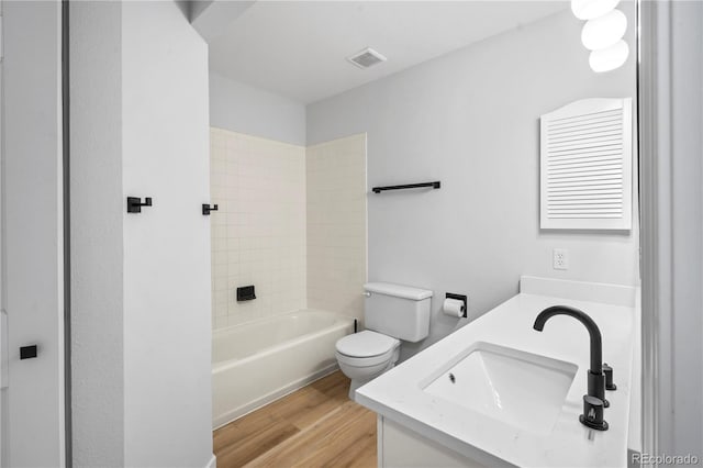 2090 S Fairplay St, Aurora, CO 80014 - full bathroom with wood finished floors, double vanity, toilet, and bathtub / shower combination