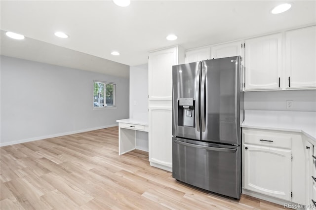 2090 S Fairplay St, Aurora, CO 80014 - kitchen featuring stainless steel refrigerator with ice dispenser, white cabinetry, light countertops, recessed lighting, and light wood-type flooring