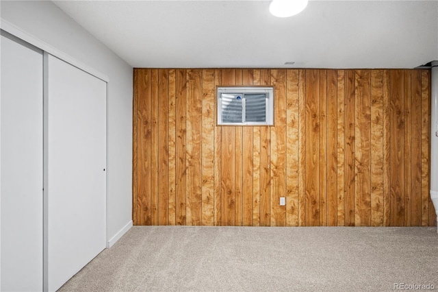 2090 S Fairplay St, Aurora, CO 80014 - unfurnished bedroom featuring carpet flooring, wooden walls, a closet, and baseboards