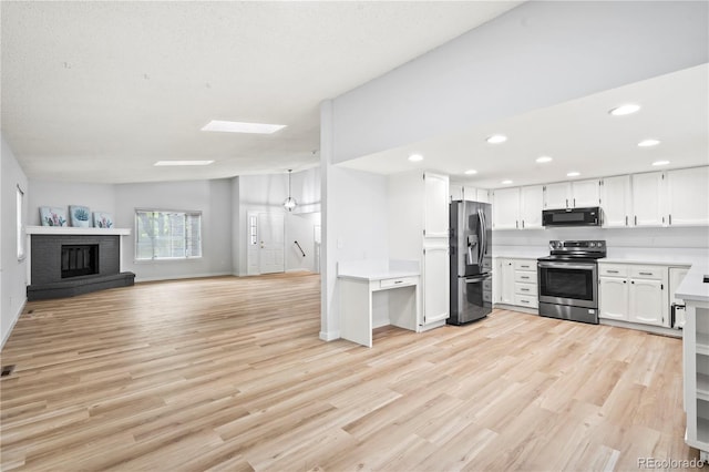 2090 S Fairplay St, Aurora, CO 80014 - kitchen with appliances with stainless steel finishes, open floor plan, light countertops, light wood finished floors, and recessed lighting