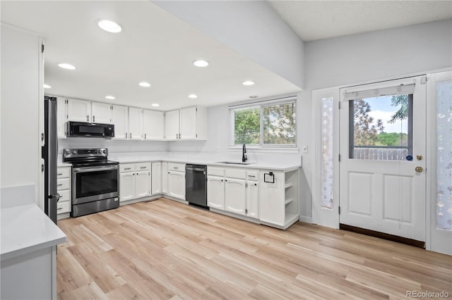 2090 S Fairplay St, Aurora, CO 80014 - kitchen with appliances with stainless steel finishes, a sink, white cabinetry, light countertops, and light wood-style floors