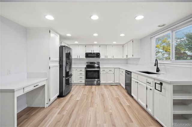 2090 S Fairplay St, Aurora, CO 80014 - kitchen with black appliances, a sink, light wood finished floors, white cabinetry, and recessed lighting