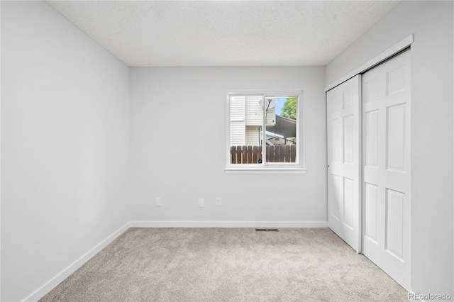 2090 S Fairplay St, Aurora, CO 80014 - unfurnished bedroom featuring carpet flooring, baseboards, a textured ceiling, and a closet