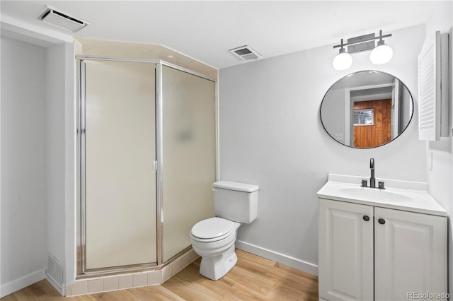 2090 S Fairplay St, Aurora, CO 80014 - bathroom with vanity, a stall shower, wood finished floors, and toilet