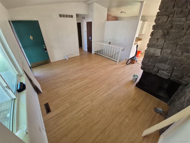 3984 S Pitkin Way, Aurora, CO 80013 - unfurnished room with wood finished floors and a stone fireplace