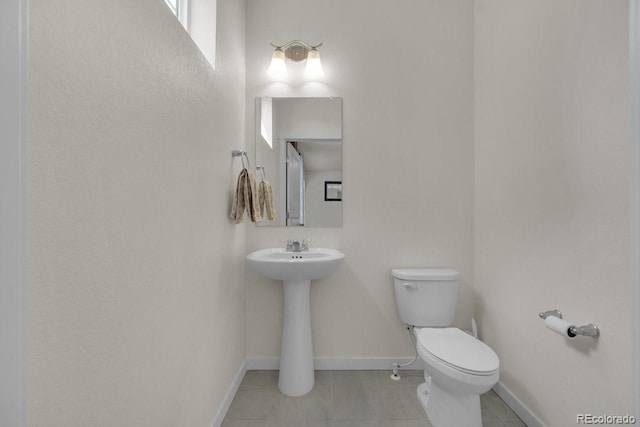 21821 E 7th Ave, Aurora, CO 80018 - half bathroom with toilet, baseboards, and tile patterned flooring