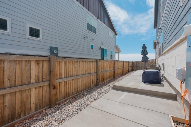 21821 E 7th Ave, Aurora, CO 80018 - view of side of property featuring a fenced backyard, a patio, and board and batten siding