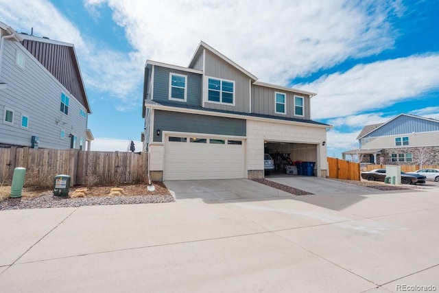 21821 E 7th Ave, Aurora, CO 80018 - traditional-style home featuring concrete driveway, board and batten siding, an attached garage, and fence