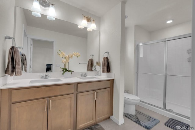 21821 E 7th Ave, Aurora, CO 80018 - ensuite bathroom featuring a shower stall, toilet, a sink, and double vanity