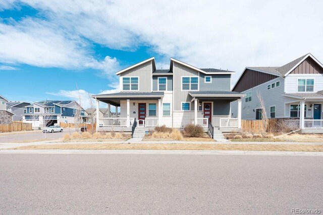 21821 E 7th Ave, Aurora, CO 80018 - view of front of home with board and batten siding, a porch, and a residential view