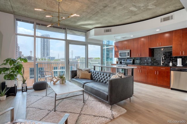 1700 Bassett St Unit 412, Denver, CO 80202 - living area featuring a wall of windows, a view of city, light wood finished floors, and healthy amount of natural light