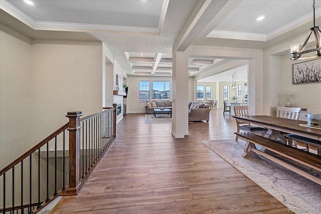 hallway featuring an upstairs landing, ornamental molding, an inviting chandelier, and wood finished floors