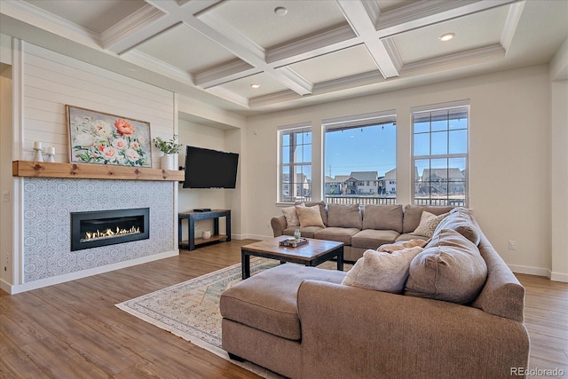 living room with beamed ceiling, wood finished floors, baseboards, and coffered ceiling