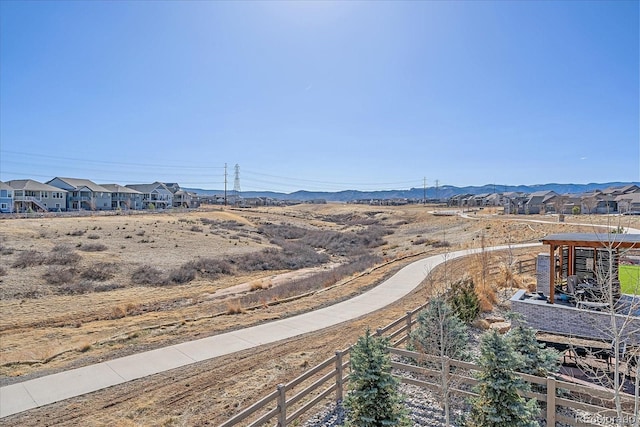 exterior space with a mountain view and fence