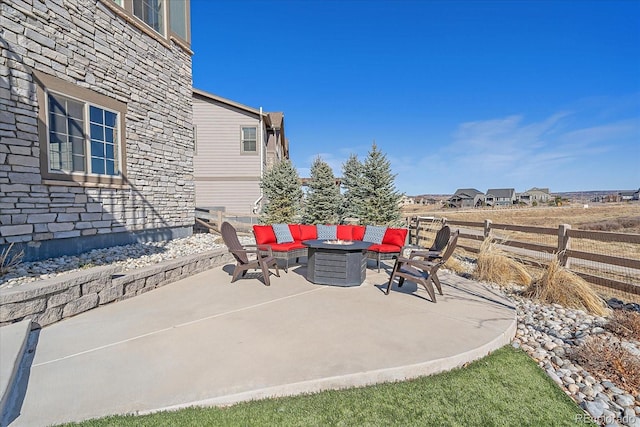 view of patio featuring fence and a fire pit