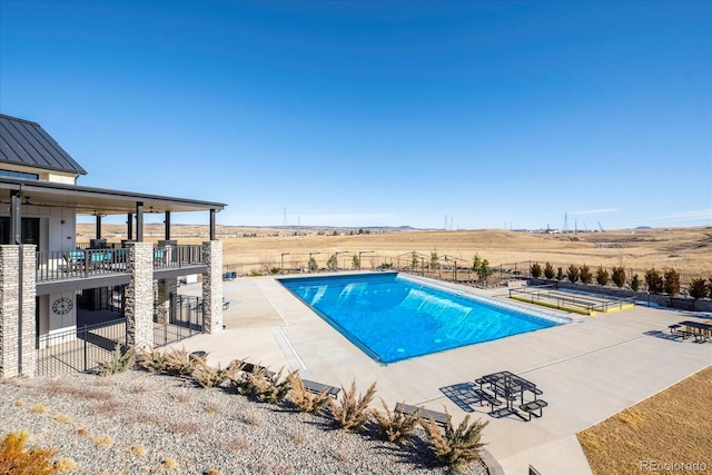 outdoor pool featuring a patio area and fence