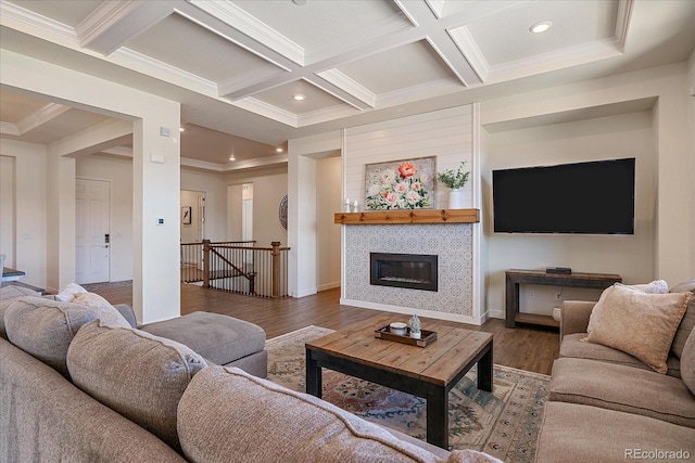 living room with beamed ceiling, wood finished floors, coffered ceiling, and ornamental molding