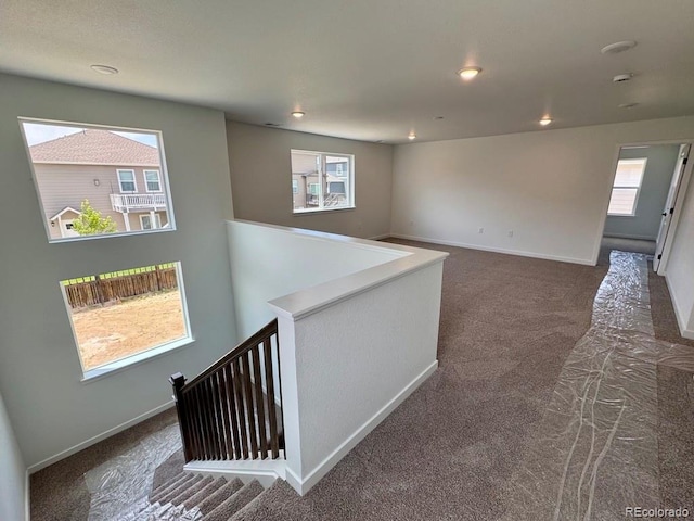 245 Wooten Ave, Brighton, CO 80601 - hall with carpet, an upstairs landing, plenty of natural light, and recessed lighting