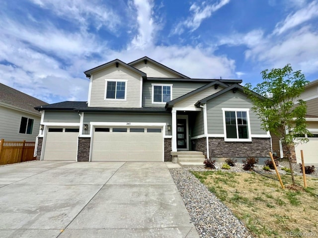 245 Wooten Ave, Brighton, CO 80601 - craftsman-style home featuring stone siding, driveway, and a garage