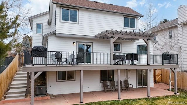 back of house with a pergola, a patio area, cooling unit, and a wooden deck