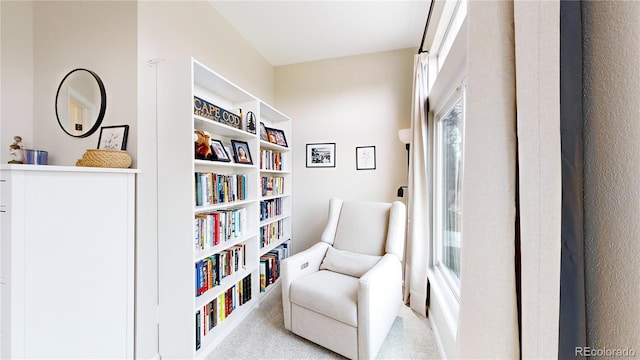 sitting room featuring light colored carpet