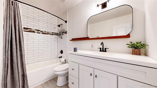 full bathroom with tile patterned flooring, vanity, toilet, and shower / tub combo