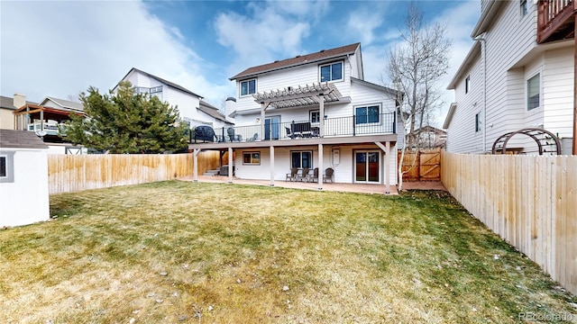 rear view of property with a lawn, a pergola, and a patio