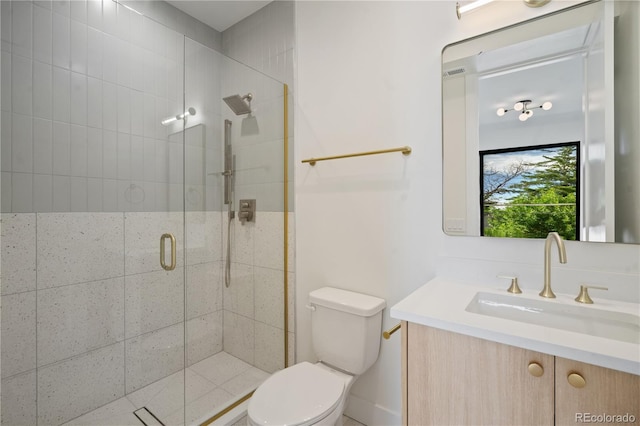 bathroom featuring vanity, toilet, and an enclosed shower