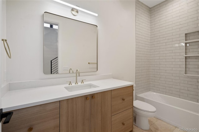 full bathroom with tiled shower / bath, vanity, and toilet