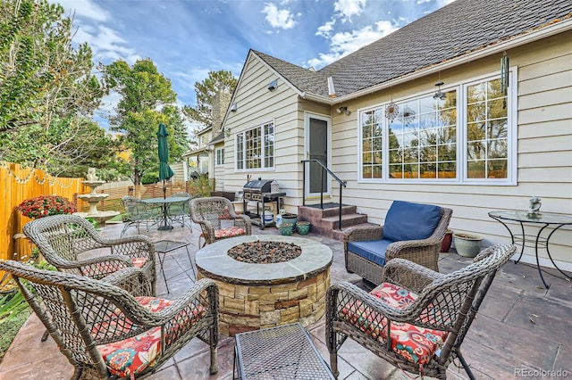 4505 S Yosemite St Unit 102, Denver, CO 80237 - view of patio featuring a fire pit, fence, and grilling area