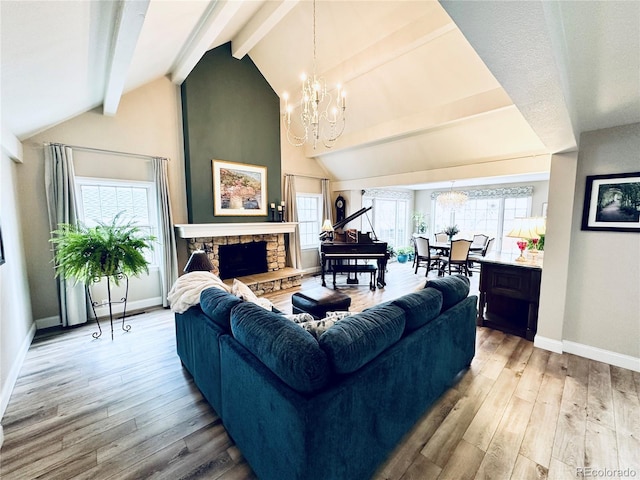 4505 S Yosemite St Unit 102, Denver, CO 80237 - living room featuring lofted ceiling with beams, wood finished floors, a healthy amount of sunlight, an inviting chandelier, and baseboards