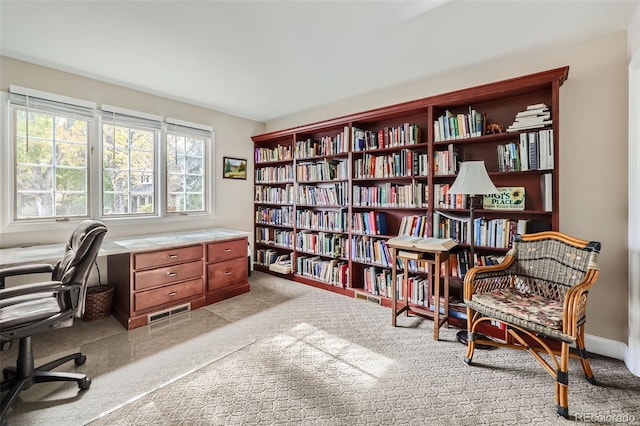 4505 S Yosemite St Unit 102, Denver, CO 80237 - home office with light colored carpet and wall of books