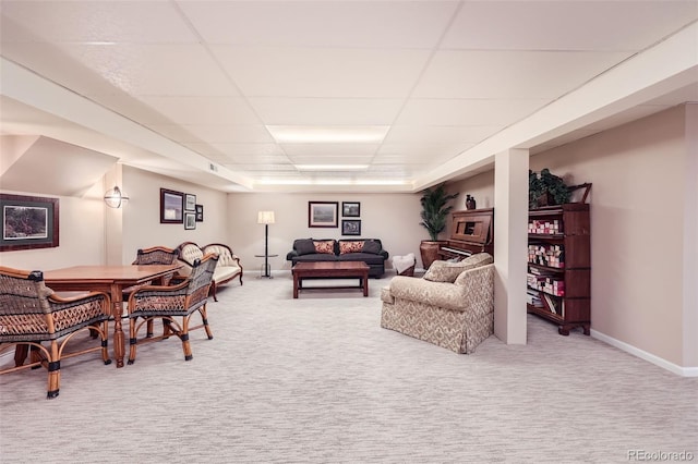 4505 S Yosemite St Unit 102, Denver, CO 80237 - carpeted living area featuring baseboards and a paneled ceiling