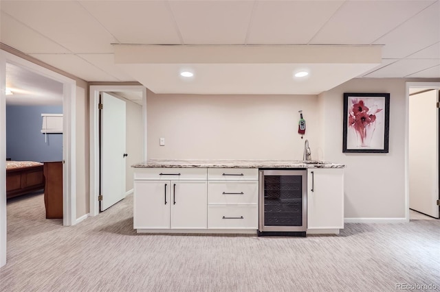 4505 S Yosemite St Unit 102, Denver, CO 80237 - bar with wine cooler, light carpet, baseboards, and indoor wet bar