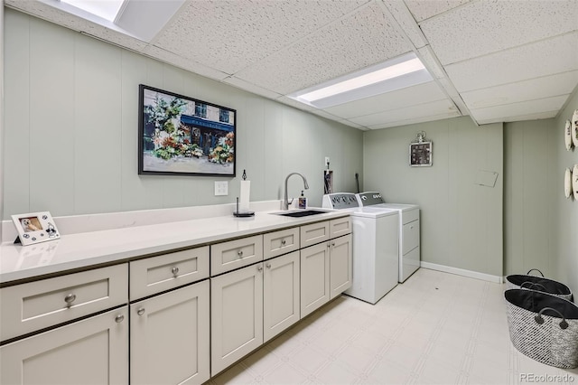 4505 S Yosemite St Unit 102, Denver, CO 80237 - laundry area with washing machine and dryer, a sink, cabinet space, light floors, and a decorative wall