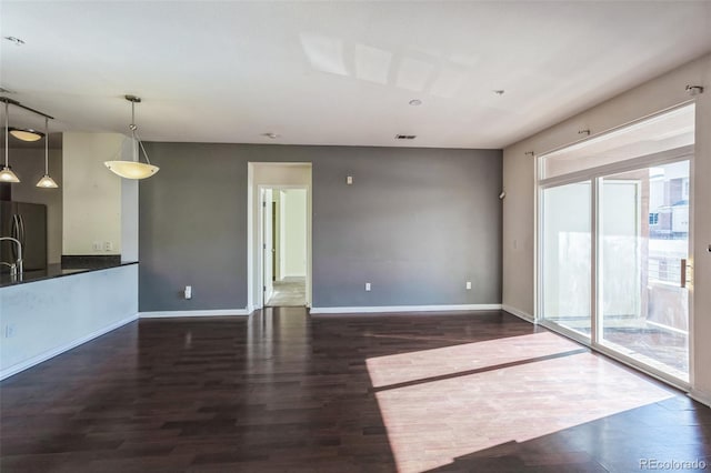 unfurnished living room with dark hardwood / wood-style floors