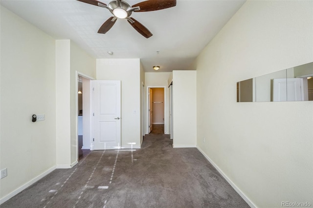 unfurnished bedroom featuring dark colored carpet and ceiling fan