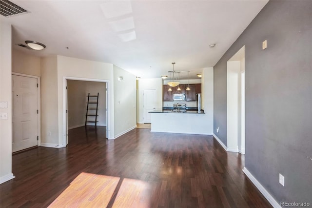 unfurnished living room with dark hardwood / wood-style floors