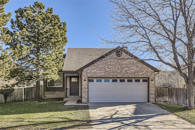 view of front of home with a front yard and a garage